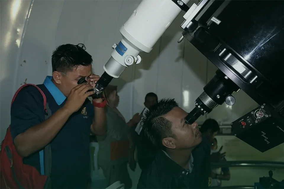 Pengunjung mencerap langit menggunakan teleskop